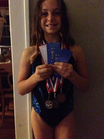 Lena Finnamore of the Maplewood Makos displays her medals.