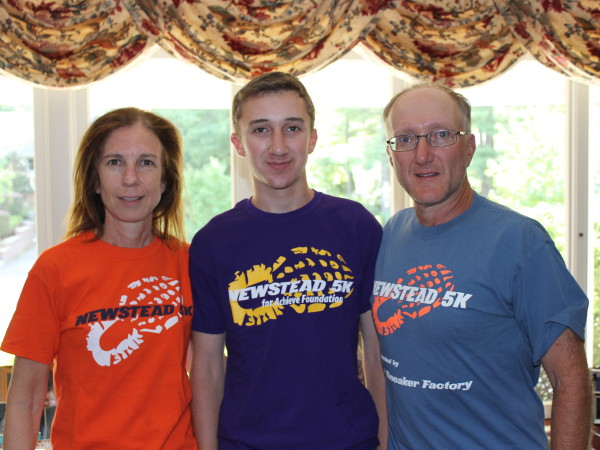 Helen, Adam and Jeff DuBowy model Newstead 5K t-shirts from past years.