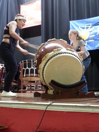 Clinton student Hannah Kennedy beats on Taiko drum