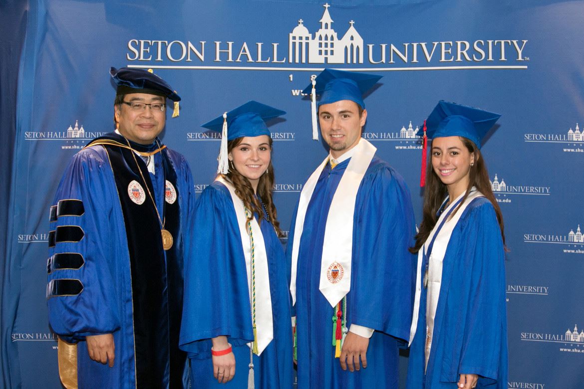 Seton Hall University President A. Gabriel Esteban congratulates 2015 graduates: featured vocalist Christine Byrne, Matthew Ullrich and Valedictorian Isabella Duarte at the 158th Baccalaureate Commencement Ceremony held May 18 at the Prudential Center in Newark.