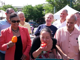 Village President Collum takes a bite out of a Jersey tomato