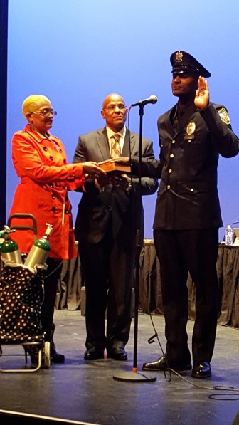 Patrol Officer Darrell Terry Jr.  is sworn in by Village President Sheena Collum .