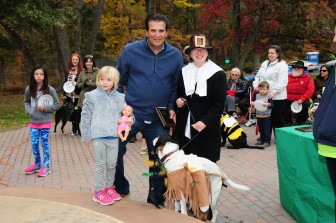 Essex County Executive Joseph N. DiVincenzo, Jr. (center) congratulates Nila Schomfield from Maplewood and her pet Georgia who dressed as Pocahontas and John Smith for winning first place in the Most Creative Costume Category.