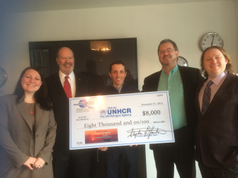 Steering Committee Members presenting the Prayer for Peace Concert proceeds for United Nations refugee relief efforts to Brian  Reich (center) are from left, Elizabeth Halpin, Associate Dean of External Affairs, School of Diplomacy and International Relations; Professor Paul Gibbons who serves on the MidAtlantic Board;  alumnus and MidAtlantic Opera President Stephen Lasher and Maestro Jason Tramm. (photo by Laurie Pine)