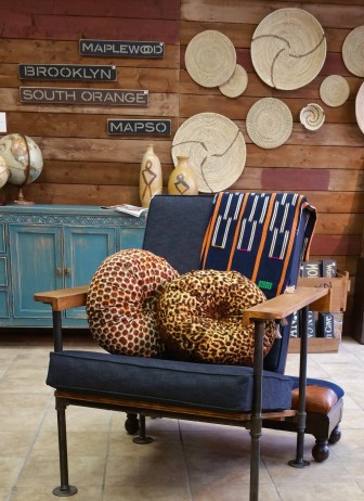Abina Wood’s pillows on one of John Carraby’s custom chairs. 