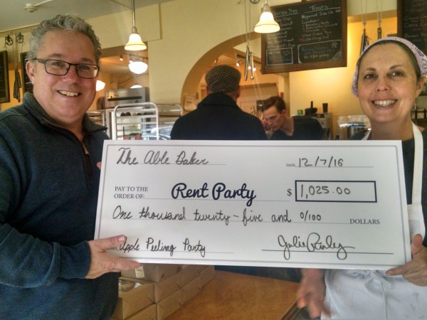 Chris Dickson of Rent Party receives check from Able Baker's Julie Pauly
