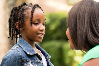 African American mother talking with her daughter.